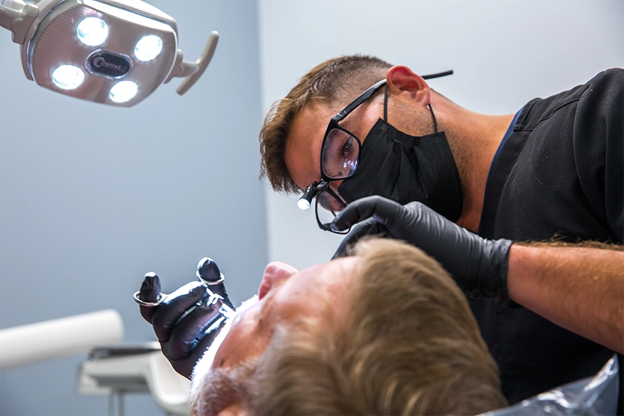 Dr. Heath Coleman with a patient in the operating chair.