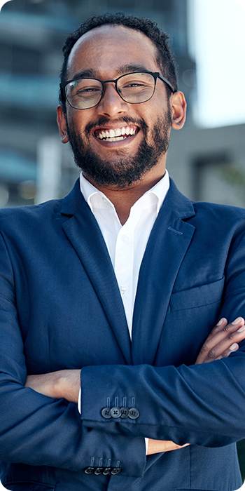 man in suit smiling with arms crossed